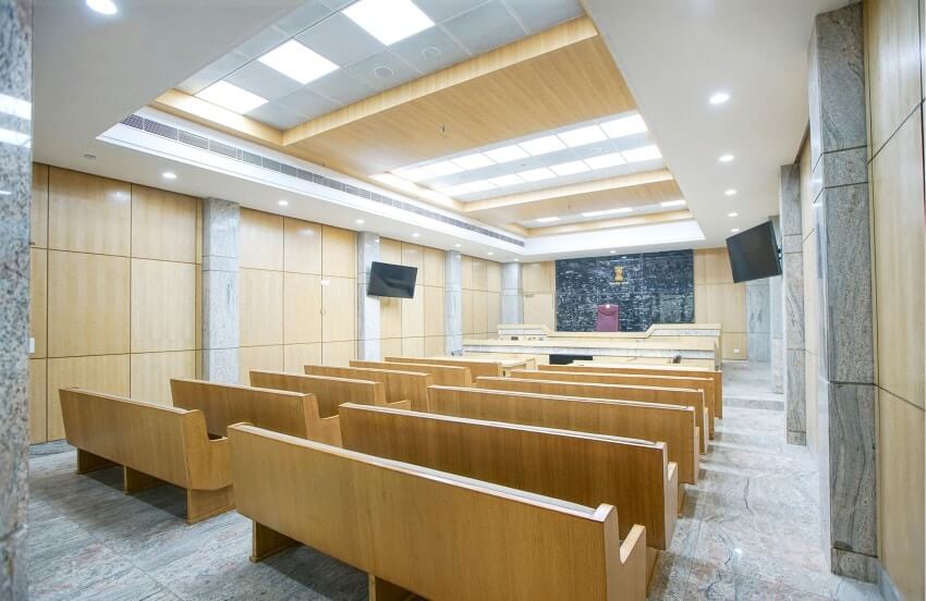 A well-equipped courtroom at Delhi High Court featuring an advanced audio-visual system for seamless communication.
