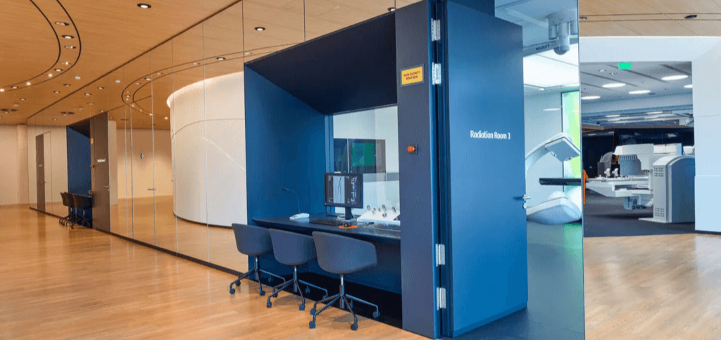 Siemens Healthineers Innovation Hub featuring a high-tech radiation therapy room with advanced medical imaging equipment.
