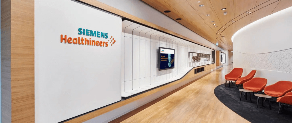 Siemens Healthineers Innovation Hub reception area with branding, modern seating, and digital displays.