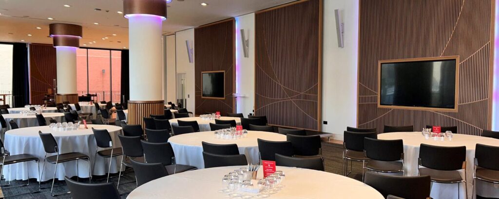 The newly upgraded Battlebridge Room at Kings Place, London, featuring a state-of-the-art AV system with Powersoft Mezzo amplifiers and Bose Professional speakers, designed for seamless event experiences.